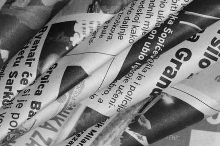 Rolled newspaper in diagonal in black and whiteの写真素材