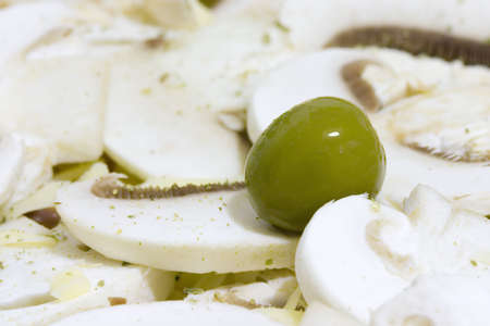 Green olive on white mushroomの写真素材