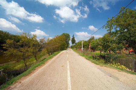 Road in old villidge with cloudy sky