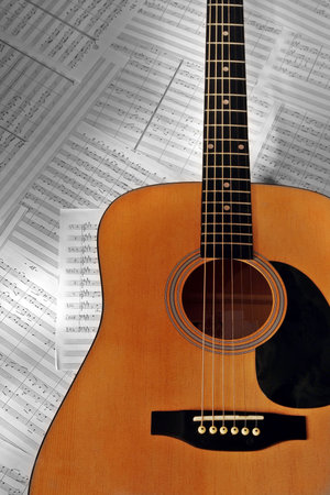 Wooden guitar on note paperの写真素材