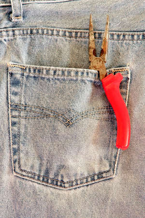 Red pliers in the back posketの写真素材