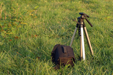 Tripod and bag on grassの写真素材