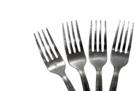 Four metal forks on white backgroundの写真素材