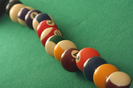 Raw of pool balls on green background