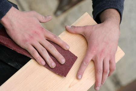 Carpenter is making wanted shapes of wooden plankの写真素材
