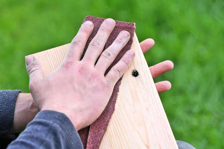 Carpenter is making wanted shapes of wooden plankの写真素材