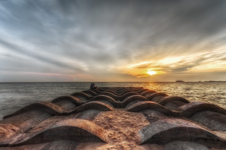 A loving couple enjoying sunsetの写真素材