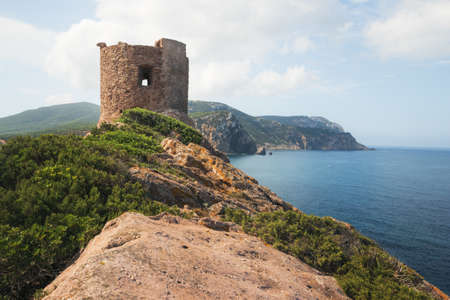 Torre del Porticciolo - Ruins of Ancient Watchtower (Nuraghe) on the Hill over the Porticciolo Beach near Alghero, Sardinia, Italyの写真素材