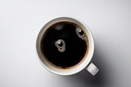 Cup of coffee on white background, top view, close upの素材