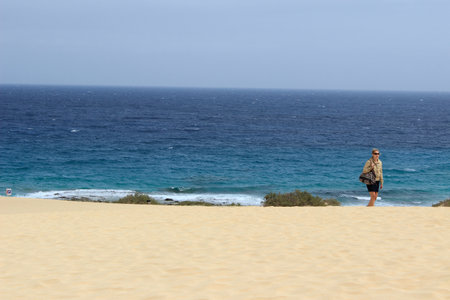 The desert dunes of Corralejo on the island of Fuerteventura. A white sand that contrasts with the blue of the ocean.の写真素材