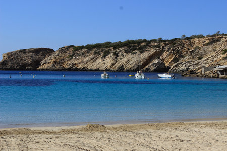 The beautiful Cala d'hort. An isolated and closed bay with a calm sea without waves. One of the most beautiful beaches in Ibiza and in the entire Mediterranean Sea.の写真素材