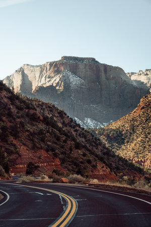 Incredible mountain view landscapes in the valley at Zion National Park in Utah United States. There are amazing colors of orange and yellows at all times of the day.の写真素材