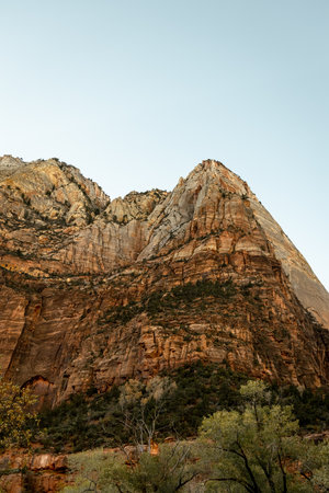 Incredible mountain view landscapes in the valley at Zion National Park in Utah United States. There are amazing colors of orange and yellows at all times of the day.の写真素材