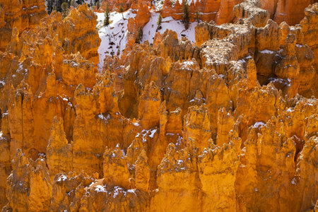 Close up view of bryce canyon national park hoodoos in winter in souther utah usa showing oranges and whites during the day.の写真素材