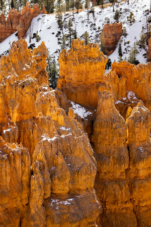 Close up view of bryce canyon national park hoodoos in winter in souther utah usa showing oranges and whites during the day.の写真素材