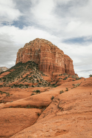 Courthouse Butte Rock in red rock formations within coconino national forest in Sedona Arizona USA against white cloud background.の写真素材