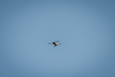Drone flying in sky against blue background for copy space.のeditorial素材