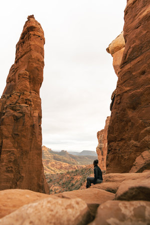 Woman looks out enjoying sunset at Cathedral Rock summit viewpoint.の写真素材