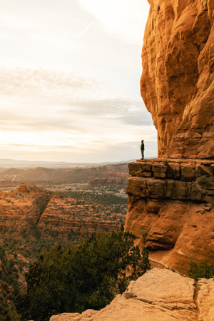 Woman looking out at dramatic sunset from Cathedral Rock.の写真素材