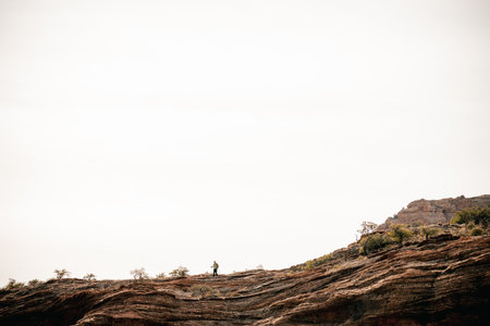 40s male hiker on ledge enjoys solitude above Boynton Canyon Sedonaの写真素材