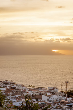 High view of Puerto Vallarta, Mexico, Jalisco sunset in January with golden yellow hues.の写真素材