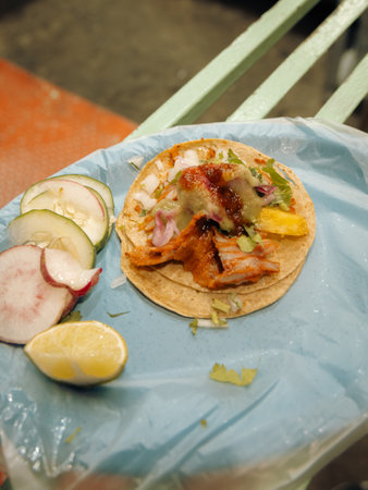 Top down view of a single Mexican al pastor street taco with cilantro, onion, and pineapple.の写真素材