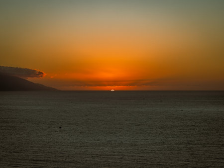 Sun setting over Banderas Bay seen from mirador at Hill of the Cross Viewpoint in Puerto Vallarta, Mexico .の写真素材