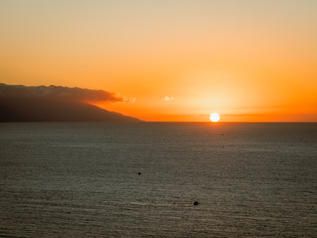 Sun setting over Banderas Bay seen from mirador at Hill of the Cross Viewpoint in Puerto Vallarta, Mexico .の写真素材