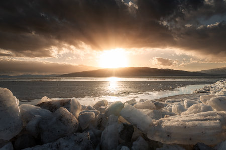 Horizontal image of Ice stacks at Vineyard Beach on Utah Lake in Utah at sunset in February 2025.の写真素材