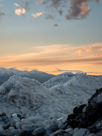 Ice stacks and snowy mountains in Utah at sunset.の写真素材
