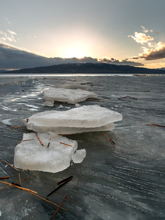 Ice stacks on Utah Lake in Utah at sunset.の写真素材