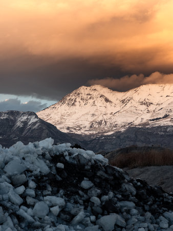 Ice stacks and snowy mountains in Utah at sunset.の写真素材