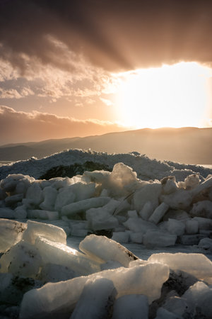 Ice stacks at Vineyard Beach on Utah Lake in Utah at sunset in February 2025.の写真素材