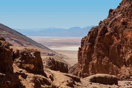 View through canyon of Death Valley basin with mountains and salt flatsの写真素材