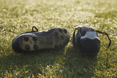 football boots on a empty football pitch ,frosty winter morning sunriseの写真素材