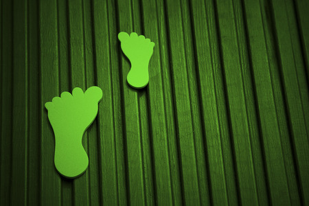 green foam feet for carbon footprint on wood deckingの写真素材