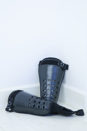 Football shin pads in the corner of a roomの写真素材