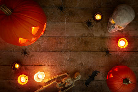 glowing pumpkins on a dark wooden cobweb backgroundの写真素材