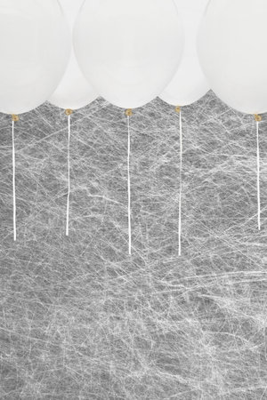 White party balloons on a grey backgroundの写真素材