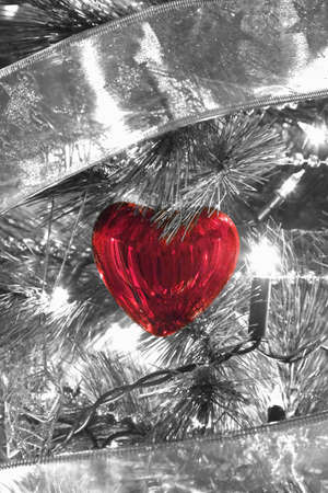 close up of Christmas heart shape tree decoration on a illuminated Christmas treeの写真素材