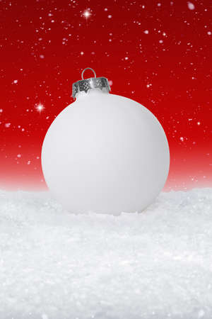 Plain White Christmas Bauble on fake white snowの写真素材