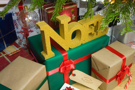 Christmas presents under an illuminated Christmas Treeの写真素材