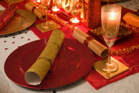 Table decorated red and gold for Christmas day dinnerの写真素材