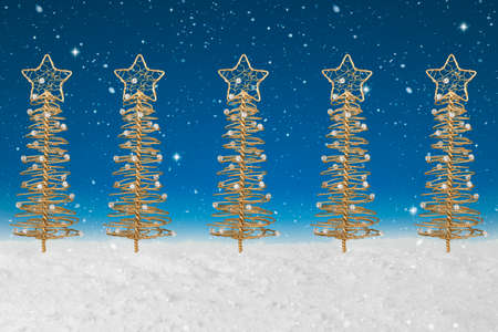 Gold wire tree Christmas Decoration on a fake snow backgroundの写真素材