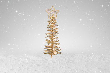 Gold wire tree Christmas Decoration on a fake snow backgroundの写真素材