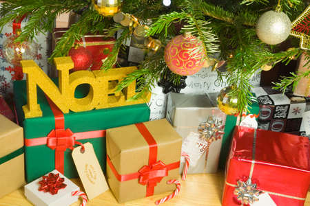 Christmas presents under an illuminated Christmas Treeの写真素材