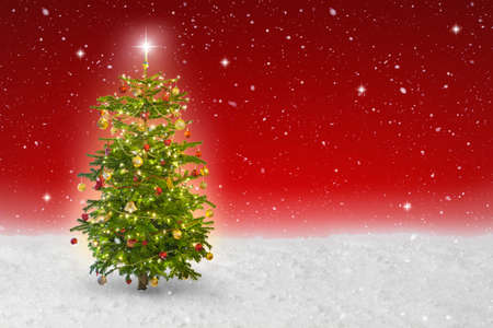 illuminated star on a christmas tree with snow fallingの写真素材