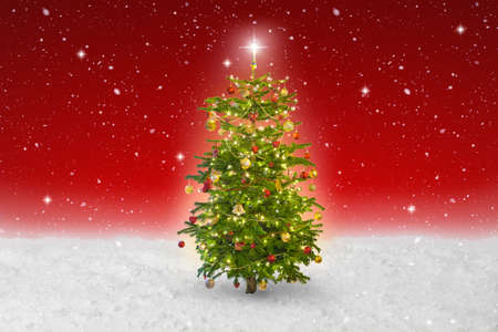 illuminated star on a christmas tree with snow fallingの写真素材