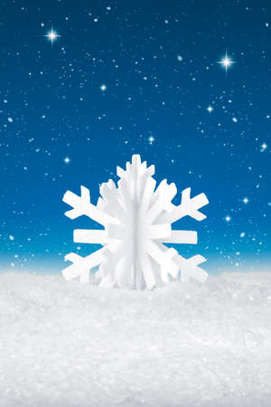 White Christmas snow flake decoration on fake white snowの写真素材