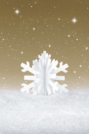 White Christmas snow flake decoration on fake white snowの写真素材